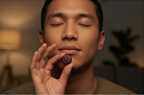 Hands holding fresh ashwagandha leaves and root